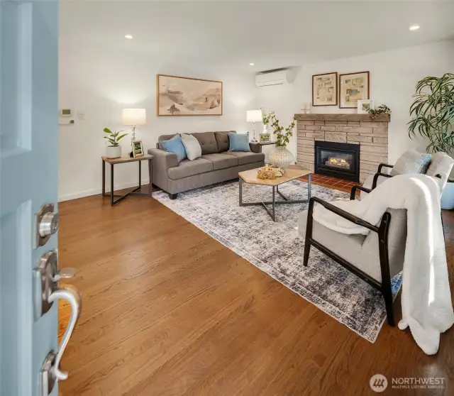 Enter into the cozy living room. Enjoy the high quality hardwood floors!