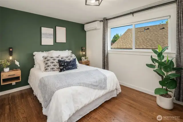 Bedroom #1 on the main level featuring floating nightstands and cute bedside sconces.