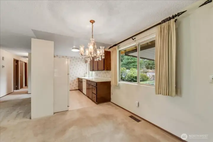 The fridge wall doesn't reach the ceiling so no worries with structural loads if you did want to open this up.