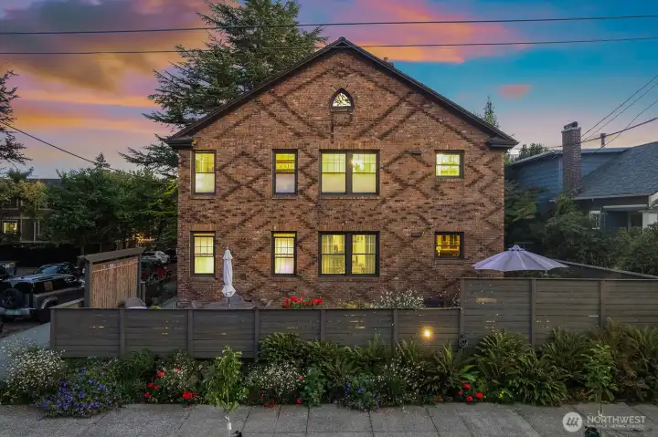 Nicely landscaped lot with a cedar fence and privacy screening.