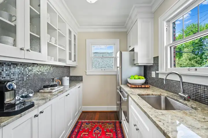High-end cabinets, granite counters, designer backsplash, and warm fir floors.