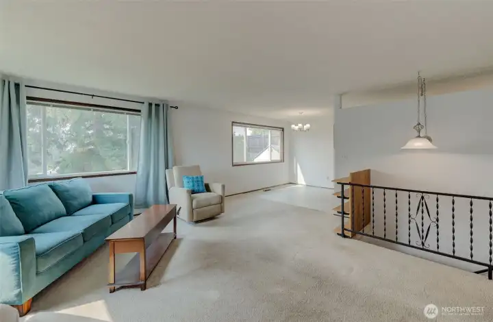 View of living room, dining area, and staircase.