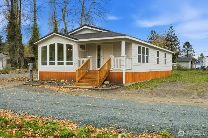 Beautiful new home with inviting front porch, crisp modern siding, and warm wood accents — move-in ready and minutes from downtown.