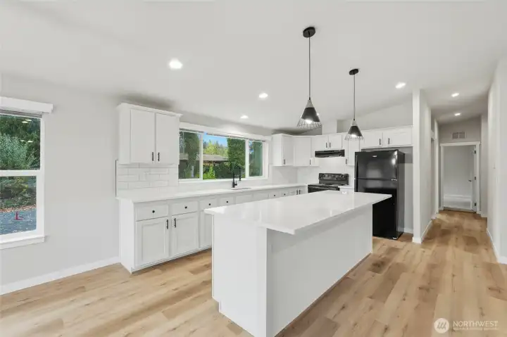 The spacious kitchen features a large island and beautiful upgrades.