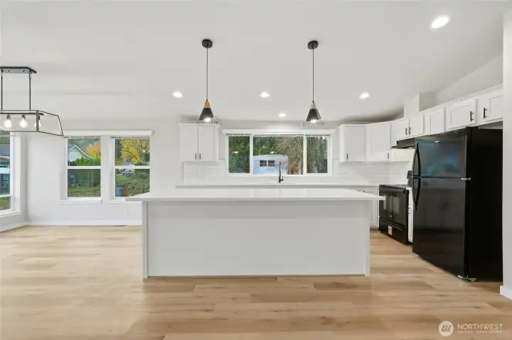 Modern light fixtures add a stylish touch to the kitchen, complementing the contemporary finishes.