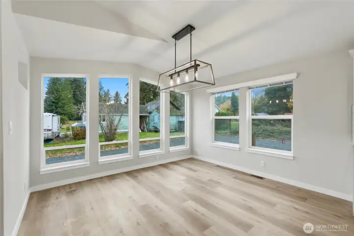 Floor-to-ceiling windows in the dining area fill the space with natural light and create a bright, open feel.