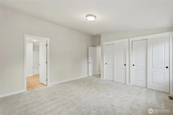 Primary bedroom features double closets and a private en suite for added convenience.