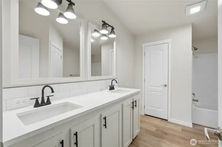 En suite bathroom features a clean, modern vanity and contemporary finishes.