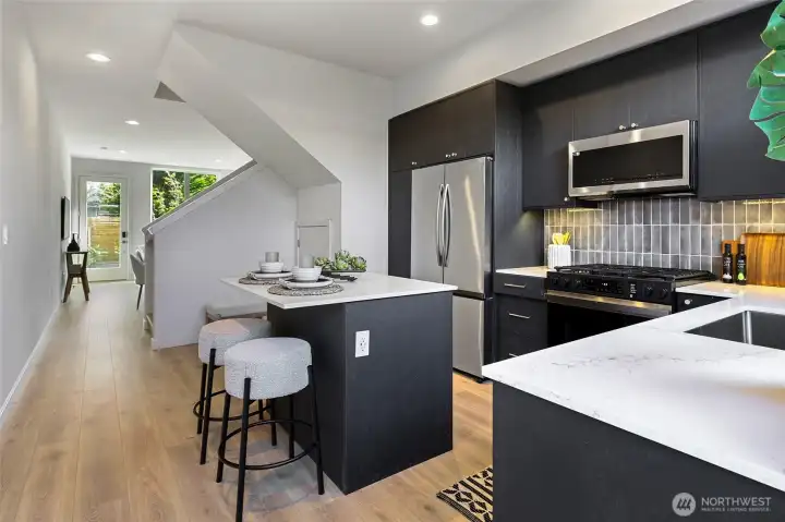 Photos of model home 9752 with similar finishes & floor plan. A functional layout that keeps everything close but never cramped—cooking and entertaining just got easier.