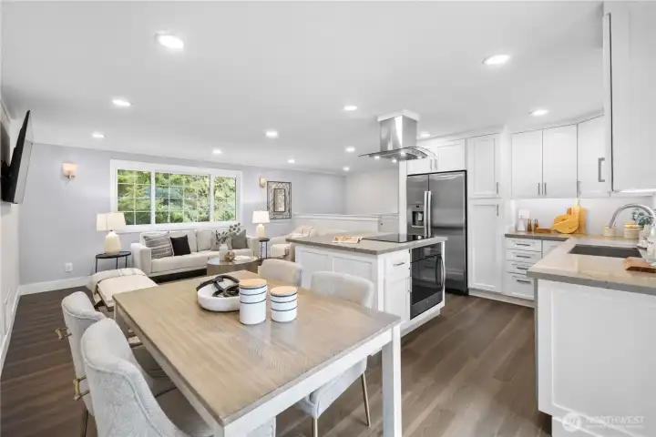 The dining area offers generous space for a full full sized table, creating a natural gathering place just steps from the kitchen. From here, meals move easily from counter to table and conversation flows naturally, keeping everyone connected while still allowing the space to feel comfortably defined. The open layout gives the table room to sit comfortably within the rhythm of the main level.