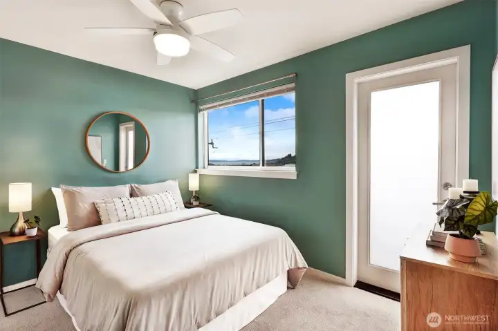 Main bedroom with views to the west.  The door leads to a deck, with space for chairs and a small table.