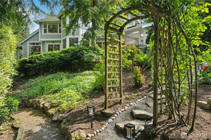 Arbor that leads you from the groomed grounds to a natural meandering path through your own woodland retreat. Arbor that leads you from the groomed grounds to a natural meandering path through your own woodland retreat.