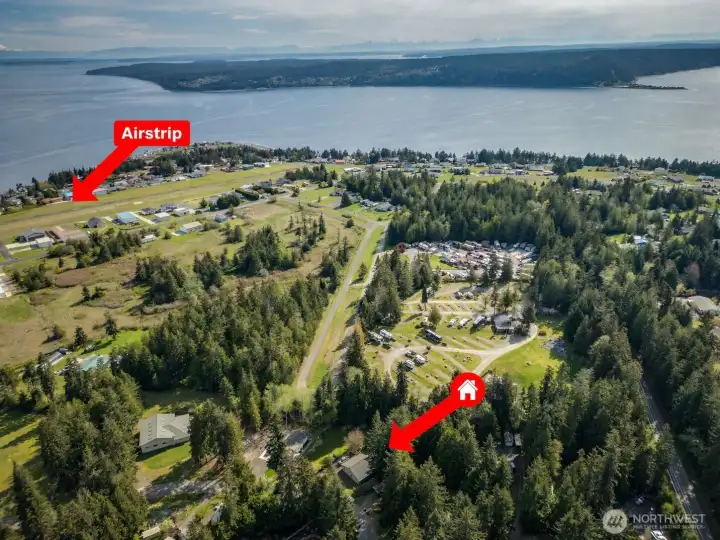 Aerial view with property location highlighted, showcasing proximity to water and community amenities