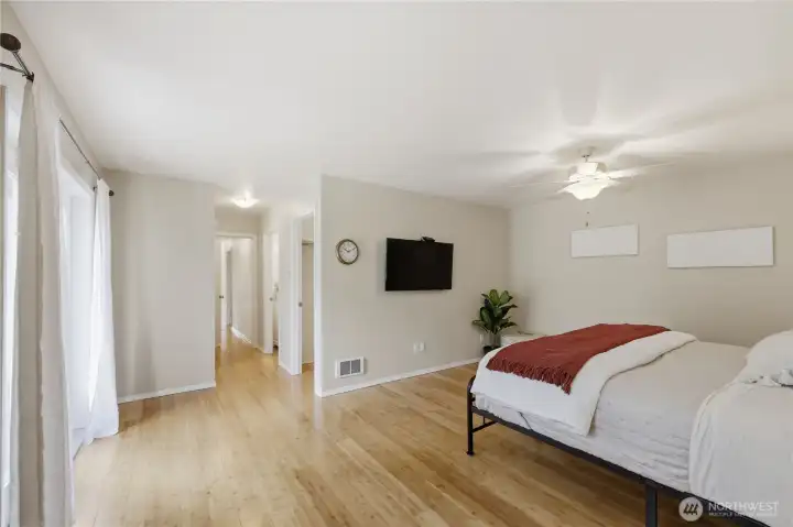 Alternate view of the primary bedroom showing layout and access