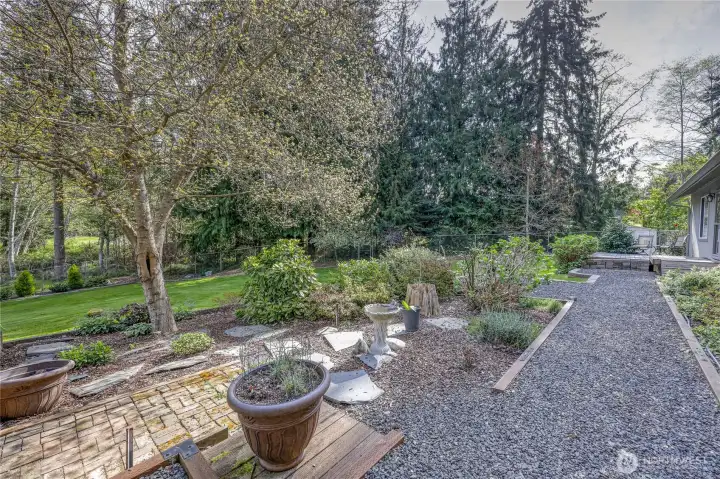 Landscaped pathway with garden features and natural surroundings