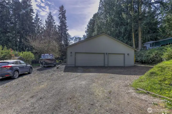 Front exterior of the home with spacious driveway and detached garage