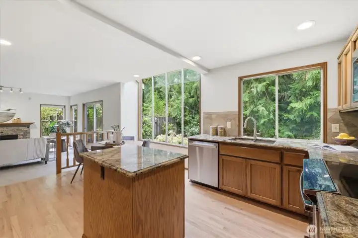 Step inside the kitchen and you will begin to get a feel for the soul of this home.  Oversized windows bring the beautiful nature in. Plenty of counter space to work with here and you will love the sweet island which provides the ideal center piece.