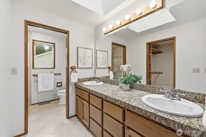 Dual vanities ensure plenty of room to share while the skylight provides the perfect natural light to get ready in the morning!