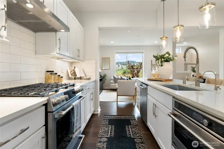 Gourmet kitchen with quartz counters and stainless appliances.