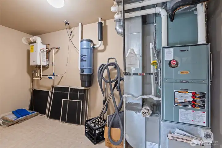 Large storage closet with tankless water heater, central vacuum and furnace