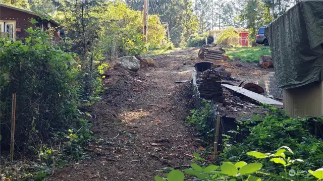 Driveway easement from the lot to the road. 20 foot wide between wire fence and neighbors shed.