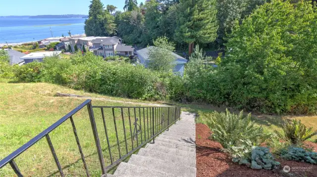 Stairs lead to open grassy space.