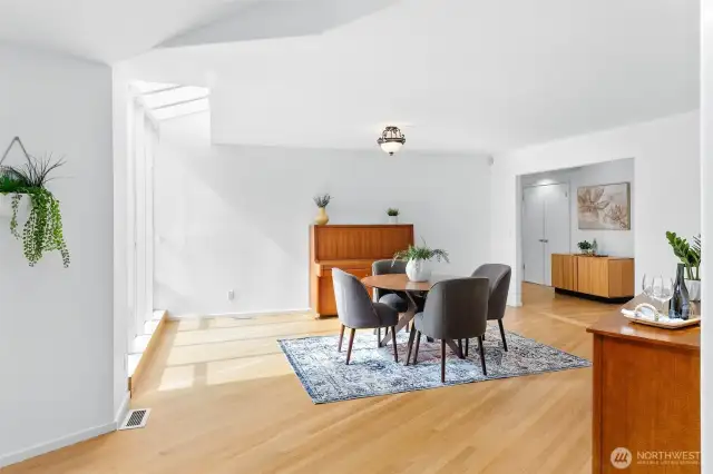 The great room gives way to dining area, flooded with light.