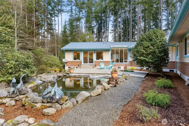 Relaxing, private backyard complete with pond.