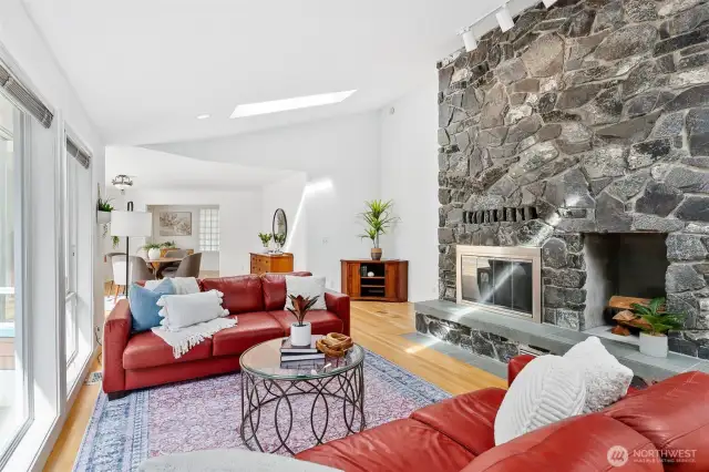 Light-filled great room with floor-to-ceiling stone fireplace.