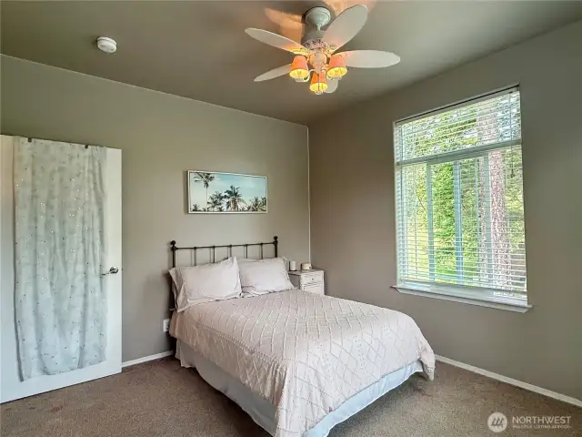 Bedroom two bright and sunny with large picture windows.