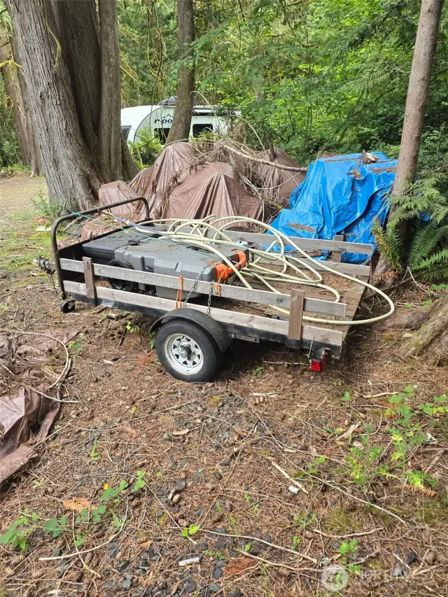 Utility trailer included in list price.