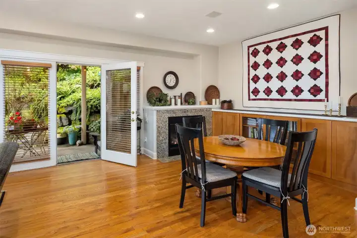 informal dining area with gas fireplace and French doors to covered outdoor patio