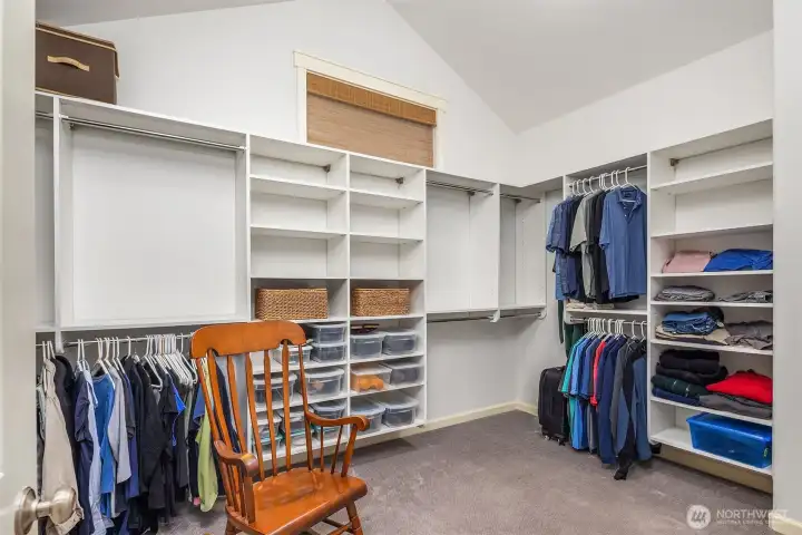 Expansive walk in closet with custom California Closets