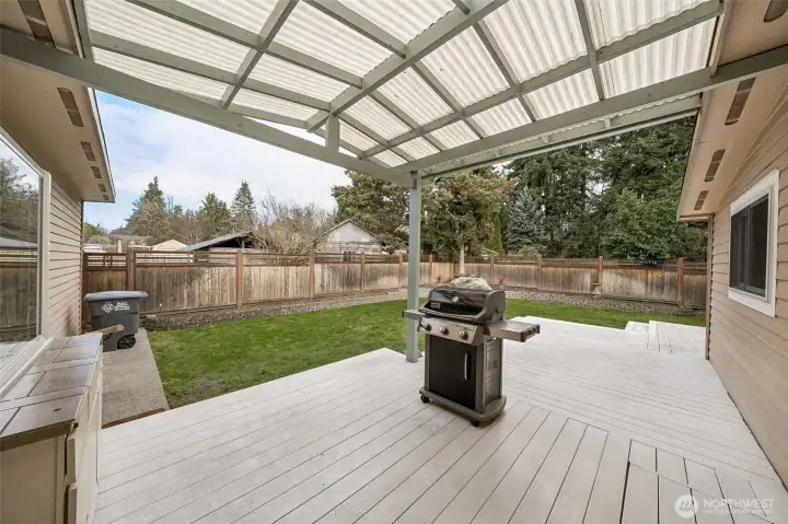 Partially covered deck just off the kitchen makes for easy BBQing and year-round enjoyment!