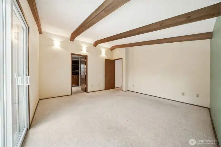 Primary bedroom also has access to the deck to enjoy the fully fenced backyard.