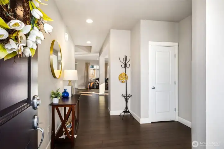 Bright and inviting entryway with sleek flooring and a modern, open feel.