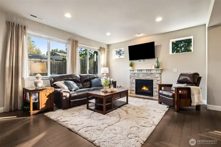 A cozy stacked brick fireplace centerpiece makes this living room perfect