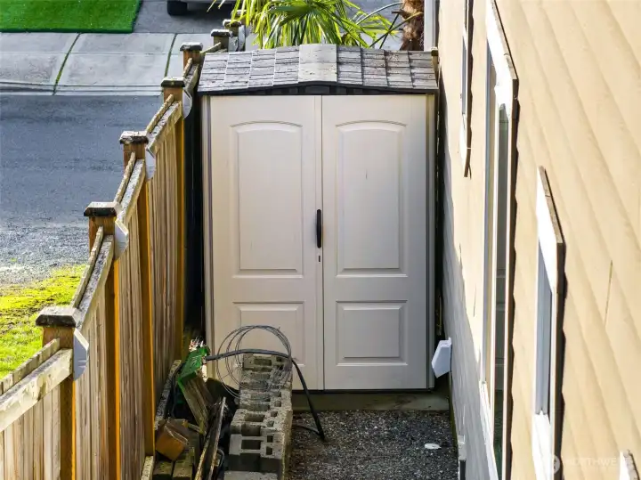 Convenient side yard space includes she with room for storage!