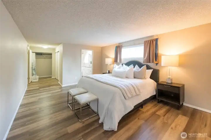 Soft, neutral tones create a calming atmosphere in the primary bedroom.