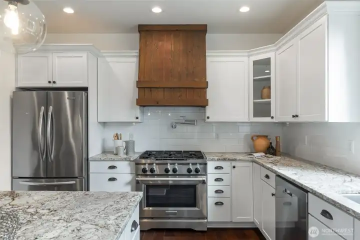 The inviting great room showcases a two-chef granite kitchen, cozy gas fireplace