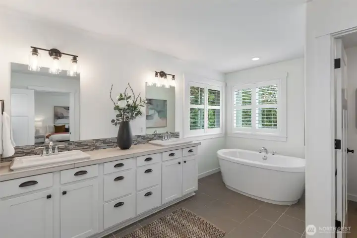 Unwind in the spacious primary suite with tranquil water views, a massive walk-in closet, and a luxurious ensuite.