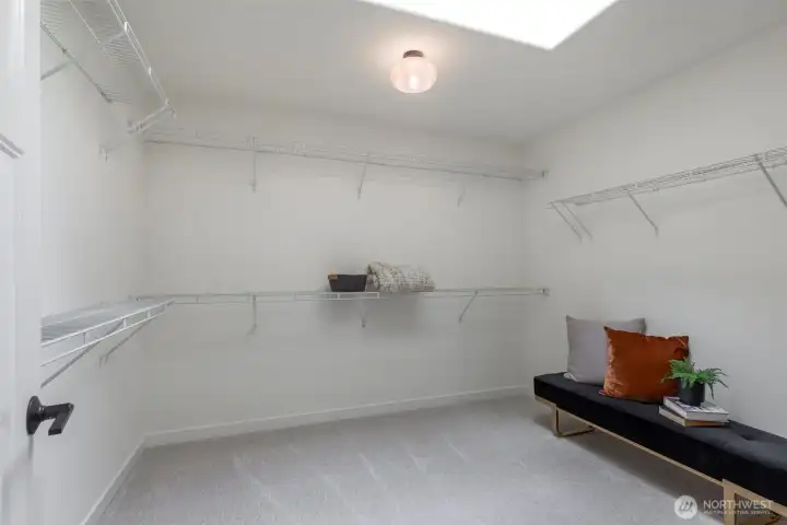 Unwind in the spacious primary suite with tranquil water views, a massive walk-in closet, and a luxurious ensuite.