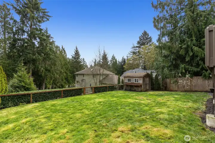 Fully fenced, level backyard with shed, where memories are made.