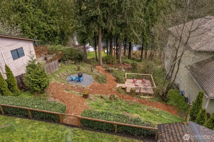 Wander down the path and gather around the firepit, relax on the peaceful side deck, or enjoy your private natural shoreline.