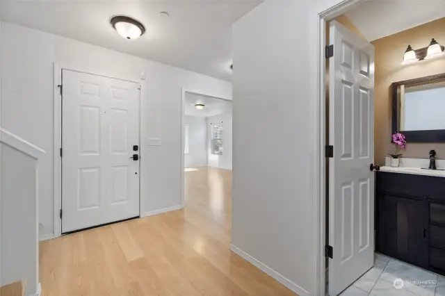 Entry door area with coat closet and powder room.