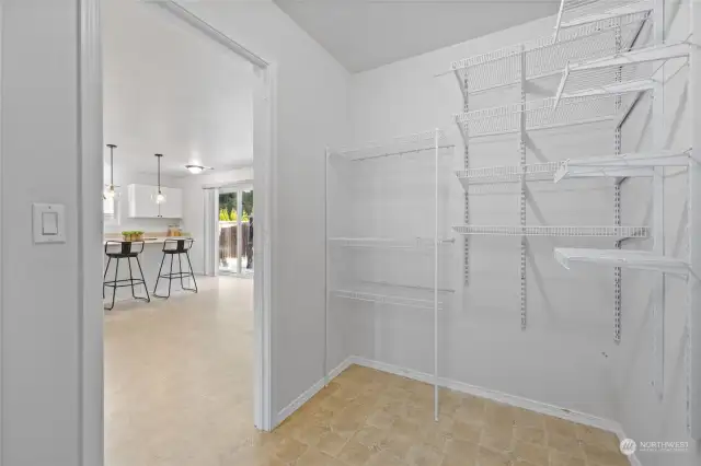 Pantry area leading from kitchen area to garage. Unpictured is more space under stairwell.