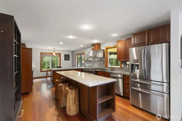 Stunning kitchen with granite and concrete counters, Stainless Steel appliances, propane gas range.
