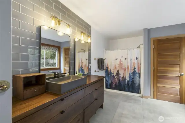 Main level full bath has a large shower and separate jetted tub.