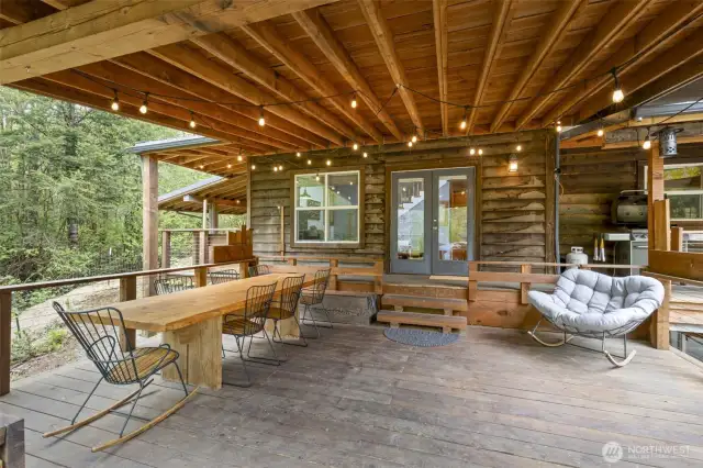 Covered deck leading to the main floor French doors. Party lights are up and ready for your housewarming event.