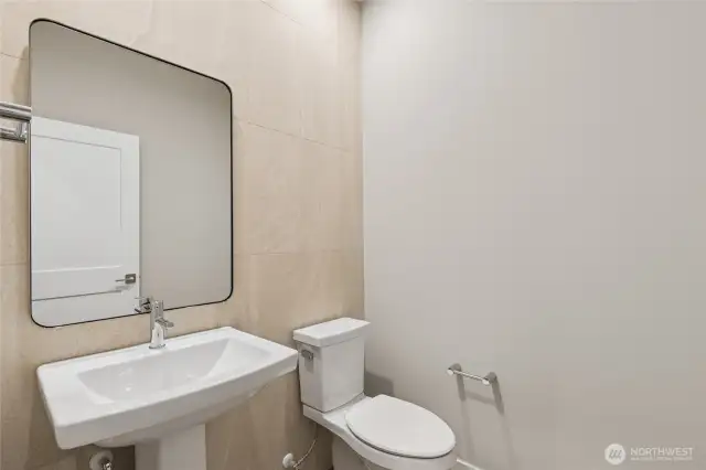 Main floor half bath. Photos are for representational purposes only.  Colors and options may vary.